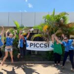 The PICCSI team hold up a banner and celebrate their work tackling cervical cancer
